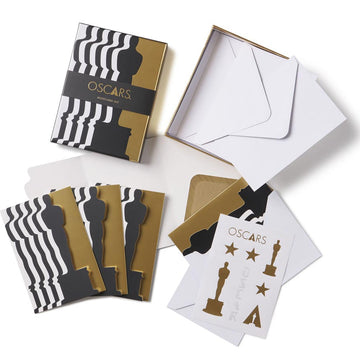 A set of Oscars-themed notecards in black, white, and gold colors with envelope, designed with elements like Oscar Statuettes and Academy Awards motifs. Discover this best-seller and fan favorite item! Exclusive Oscars Black/White/Gold note card set of 12 with tri-fold cards 4.25 x 6 when folded, includes envelopes and sticker sheet